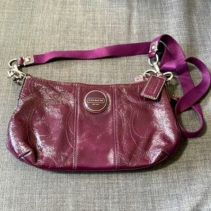 Small purple Coach bag.